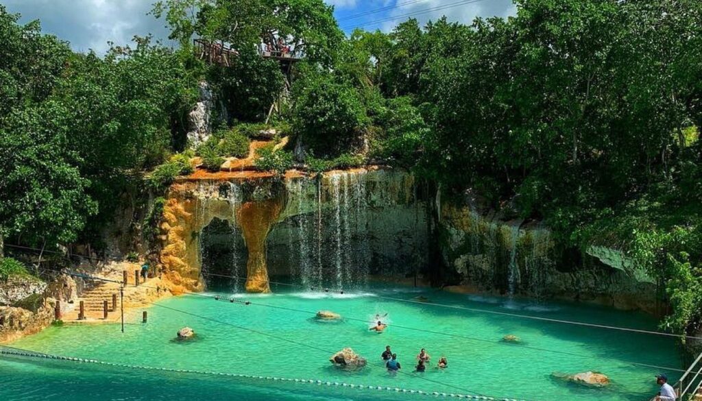 Turquoise water cenote surrounded by lush tropical vegetation in the Dominican Republic.