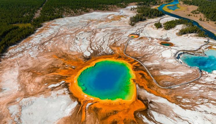 The vibrant and colorful Grand Prismatic Spring in Yellowstone National Park, one of the best places to visit in the USA, showcasing stunning natural beauty and unique geothermal features. A top tourist attraction in the USA