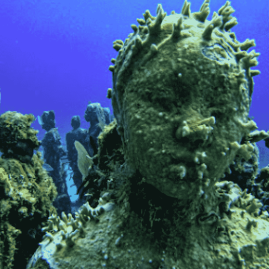 Underwater statues covered in marine life at the Cancun Underwater Museum (MUSA)