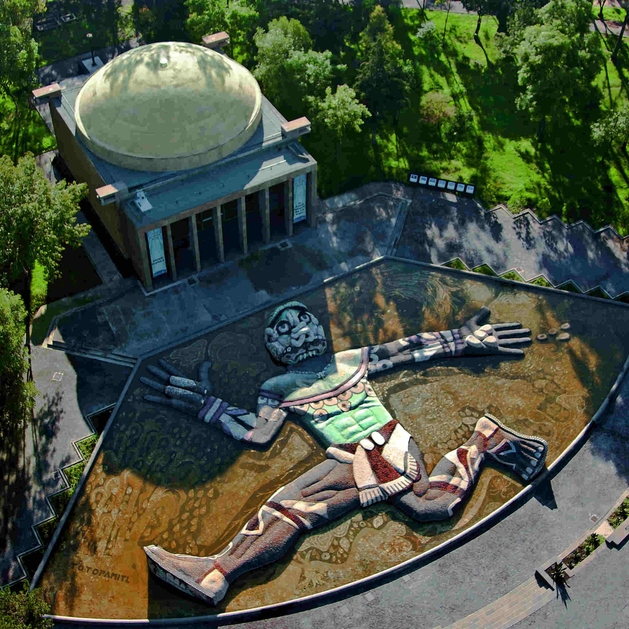 Overhead shot of the reclining Tláloc sculpture and surrounding park.
