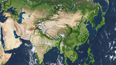 Satellite view of Asia showing landmasses, bodies of water, and cloud cover.